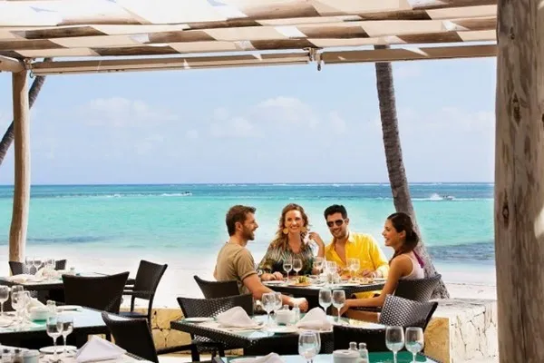 Group of holidaymakers enjoying dinner on the Dominican Republic beach. 