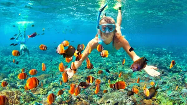 The girl is engaged in snorkelling in the Red Sea.